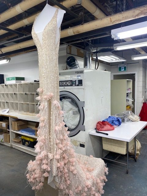 Light pink beaded gown with feather floral details at the bottom